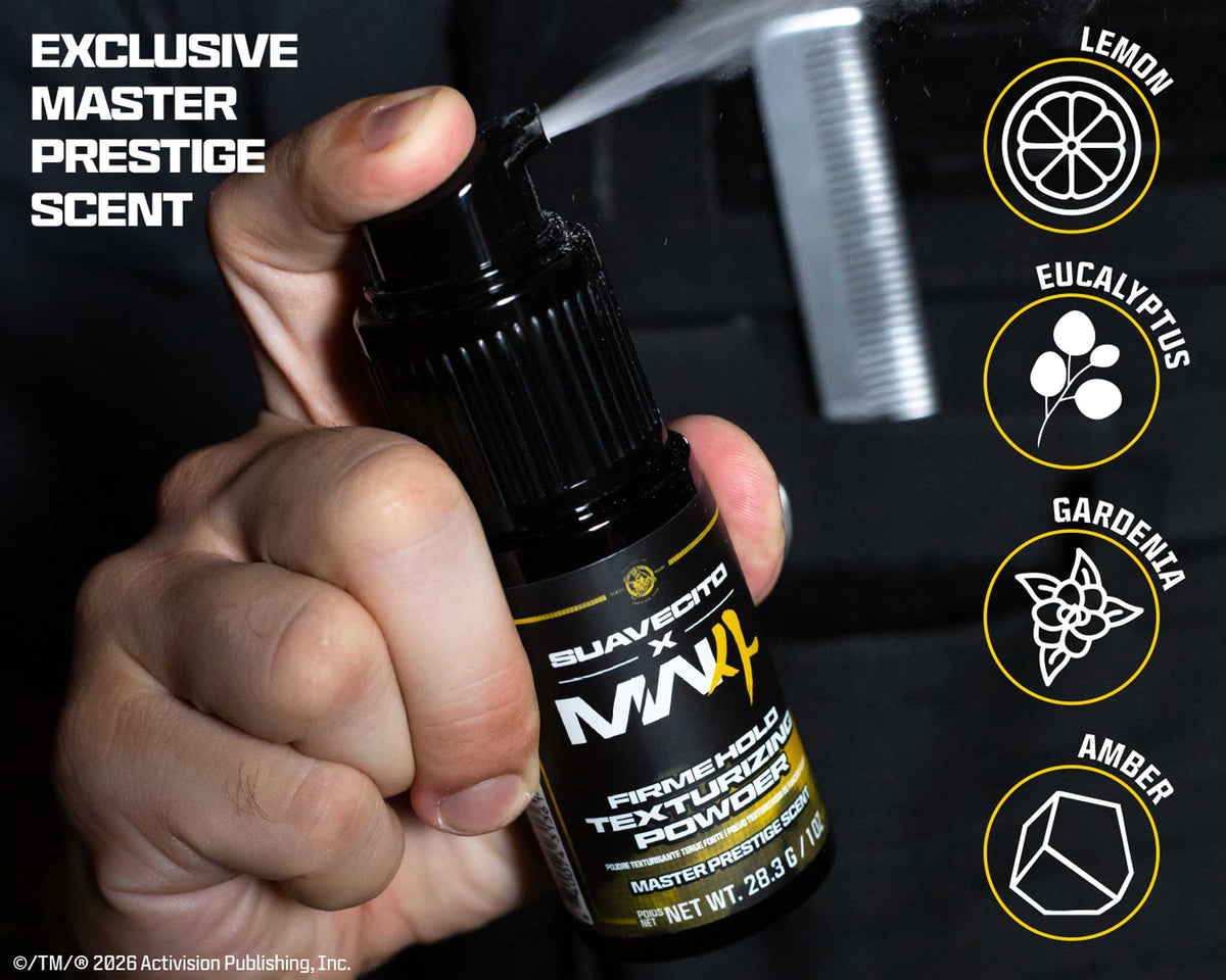 A hand holds a black spray bottle labeled Suavecito x MW Firming Agent Textured Powder, with a comb visible behind it as if demonstrating scent application. The image includes scent callouts reading Lemon, Eucalyptus, Gardenia, and Amber, plus text stating Exclusive Master Prestige Scent.