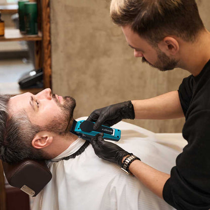 Barber using the lightweight GAMMA+ Shorty Clipper for a precision fade