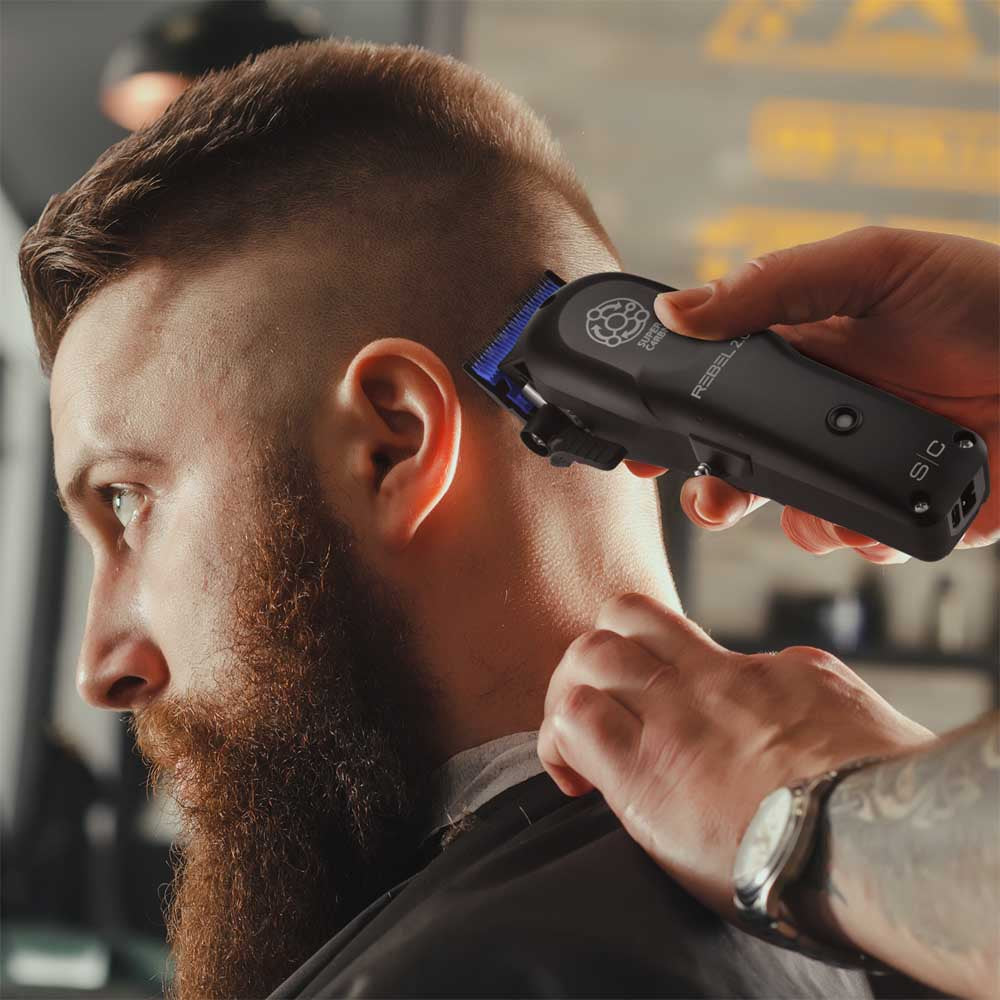 Barber using the StyleCraft Rebel 2.0 professional hair clipper to execute a clean fade haircut