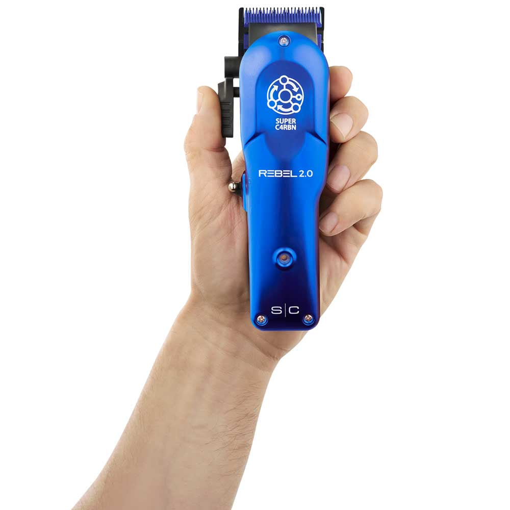 Hand holding the StyleCraft Rebel 2.0 professional hair clipper in blue housing, showcasing its ergonomic design and Super C4RBN motor branding