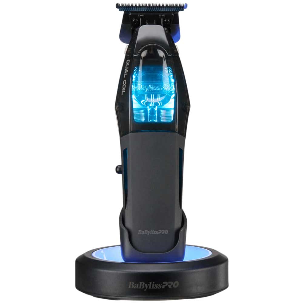 BaBylissPRO FX95T cordless trimmer sitting on its wireless charging dock with USB-C cable and zero-gap tool included.
