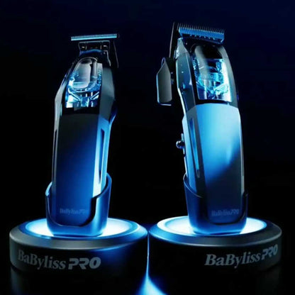 BaBylissPRO trimmer and Clipper displayed side-by-side on glowing blue circular bases, showcasing the front and profile views of the transparent housing and internal motor.