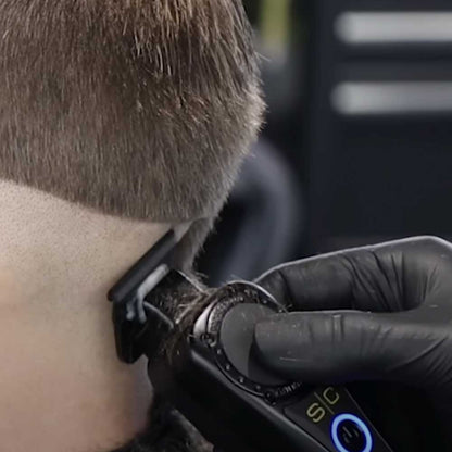 Professional barber adjusting a StyleCraft trimmer blade for zero-gap alignment