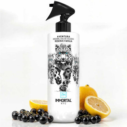 Bottle of Immortal NYC Aventura with lemons and black berries on a white background