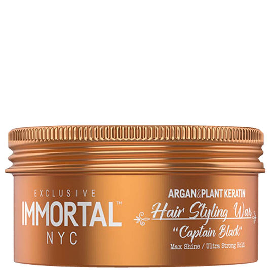 Bronze jar of Immortal NYC hair styling wax on a white background
