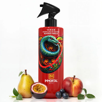 Red bottle of Immortal NYC Venom cologne with colorful snake design, surrounded by fruits on a white background