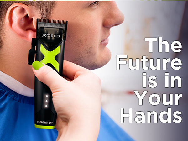Close-up of a professional barber holding a black and orange cordless trimmer to execute a crisp fade, featuring prominent marketing text across the top that reads "The Future is in Your Hands."