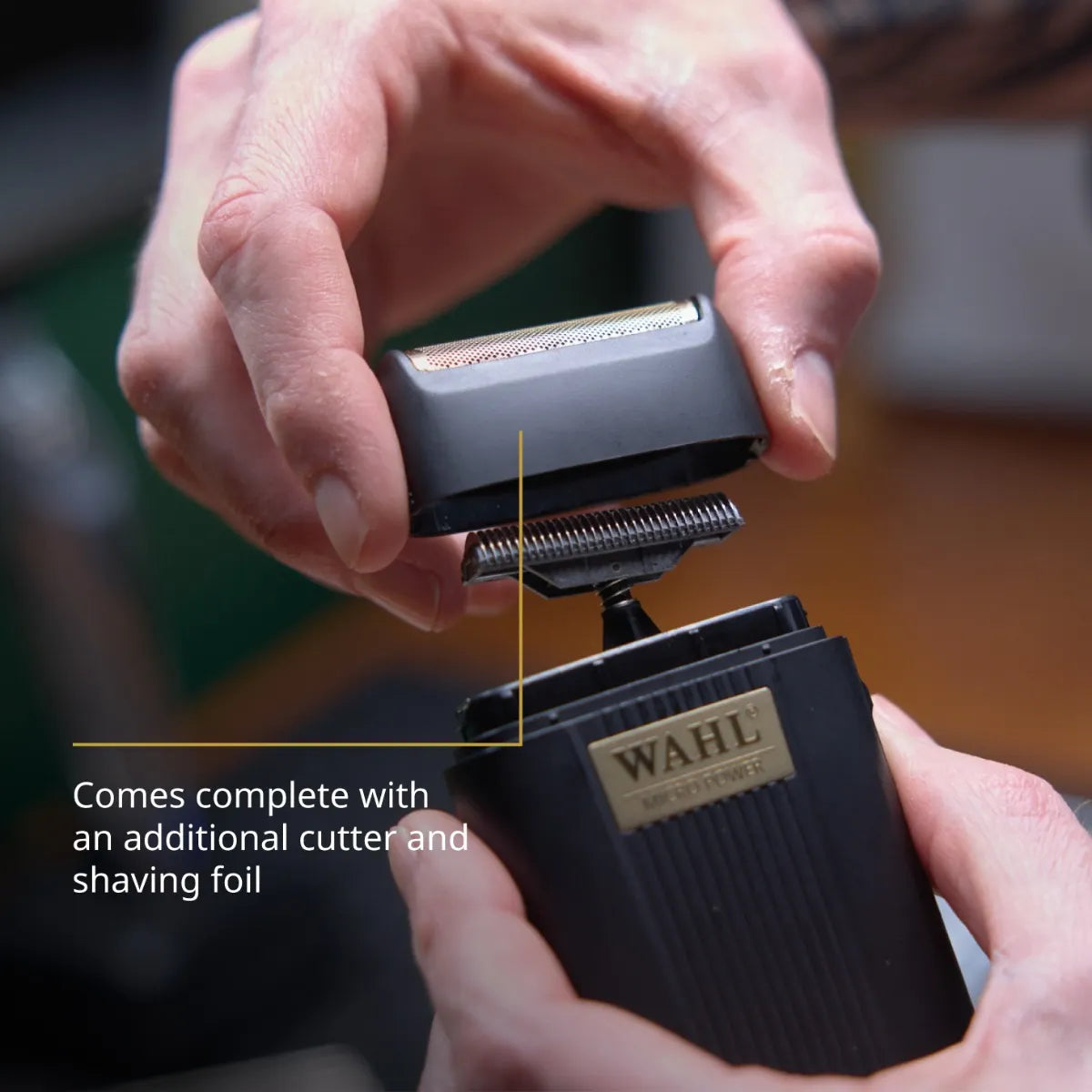 Wahl electric shaver with additional cutter and shaving foil being attached, on a blurred background.