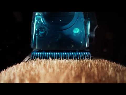 Close-up video thumbnail showing hair being precisely trimmed by the BaBylissPRO FX95T Dual-Coil Motor Trimmer, highlighting the illuminated blue internal components of the housing.